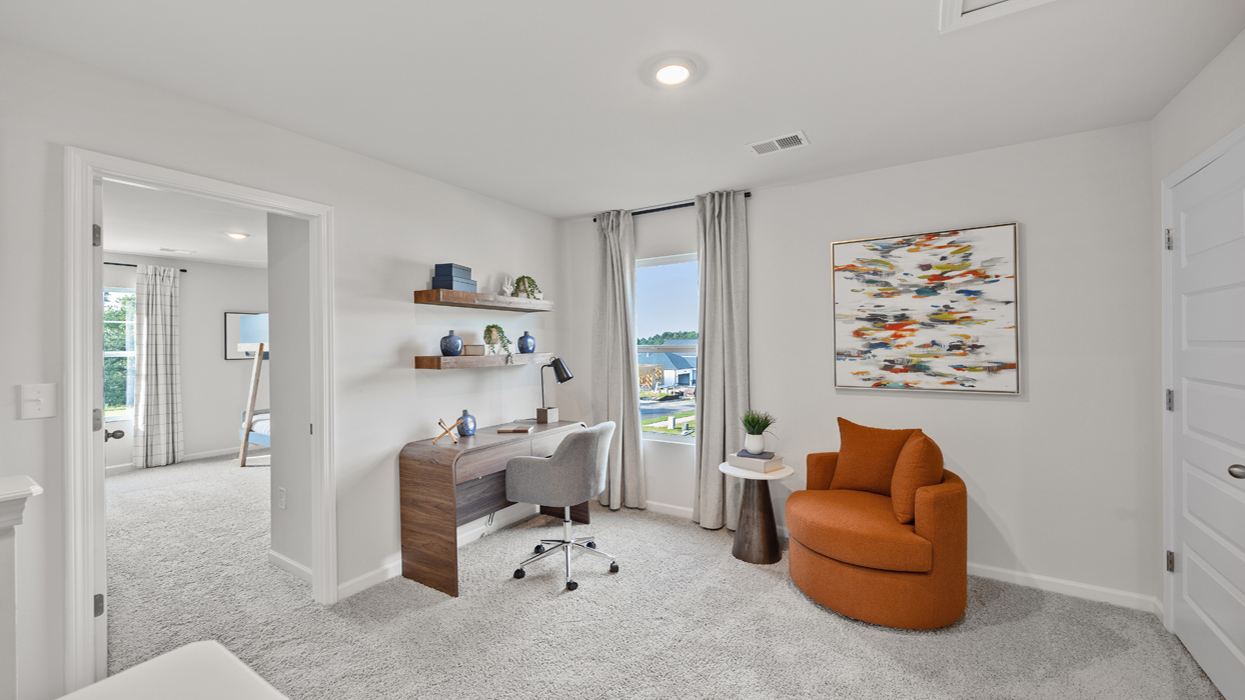 Large loft at top of stairwell with guest bedroom doors on left