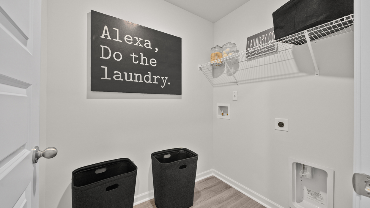 Laundry room with appliance connections and shelving above
