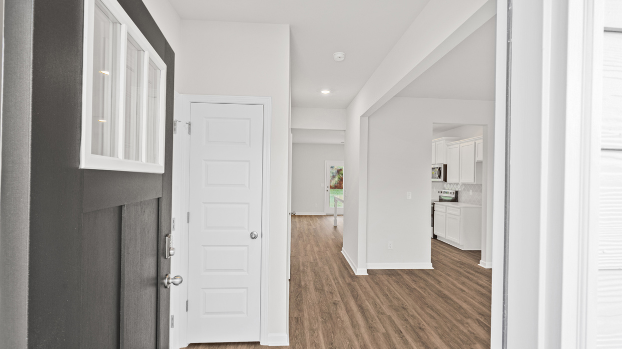 Front door opening to entryway with flex room to right.