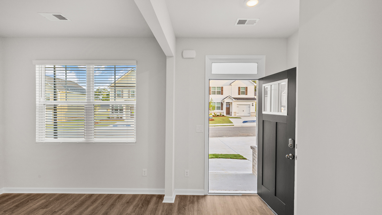 Front door opened with flex room to the left.