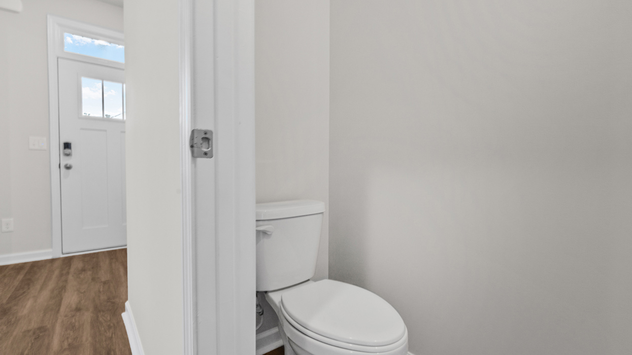 Half bath on main with commode and pedestal sink.