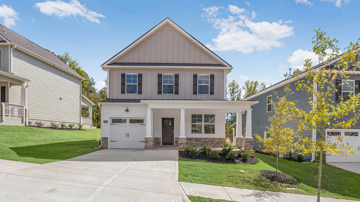 Two story home with covered front porch and one car garage