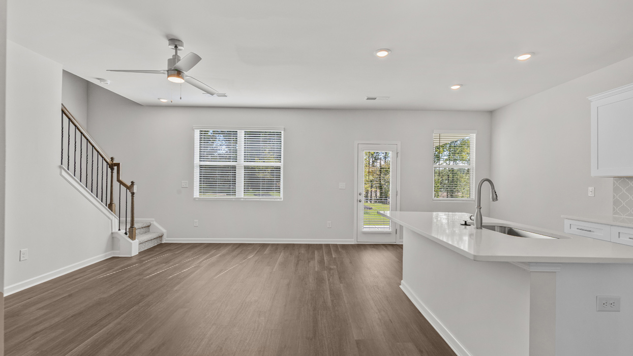 Open plan with living and dining room overlooking bright modern kitchen