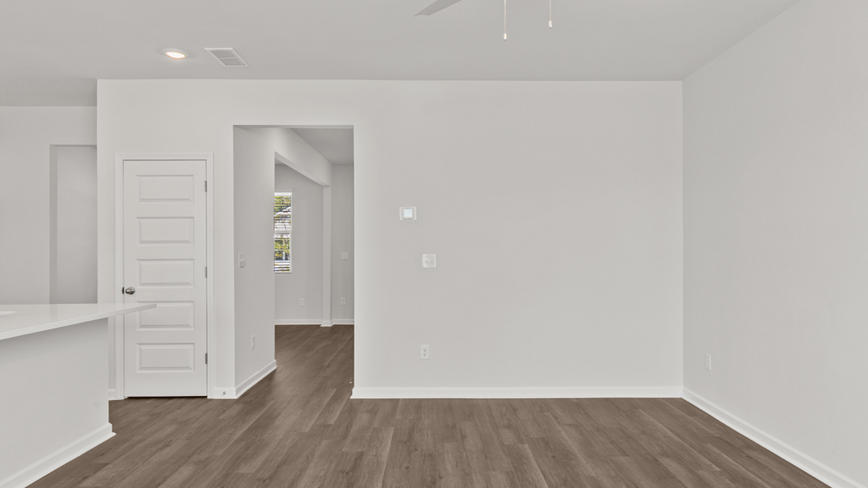 Open plan with living and dining room overlooking bright modern kitchen