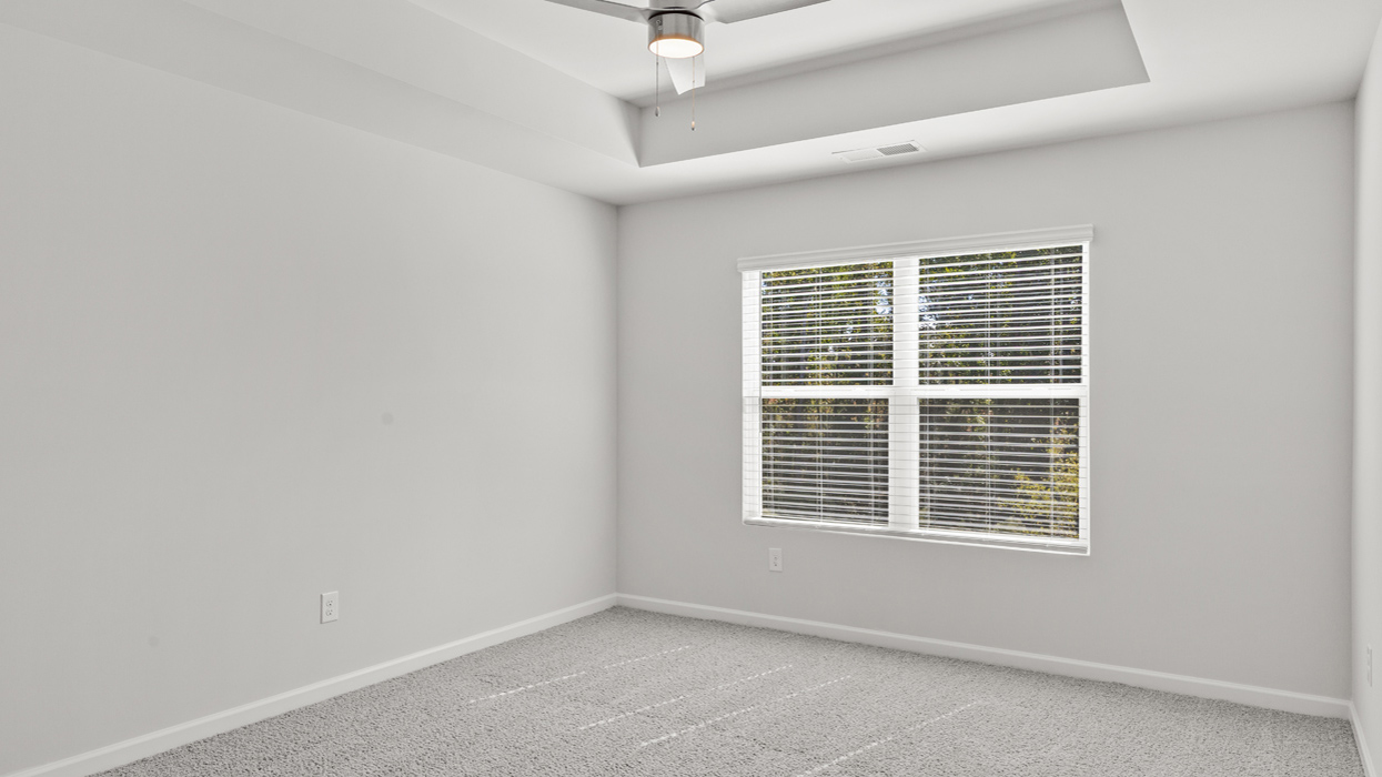 Primary bedroom on second floor with tray ceilings