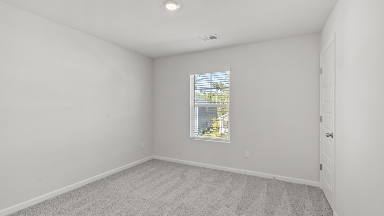 Guest bedroom upstairs with carpet and flush mount light
