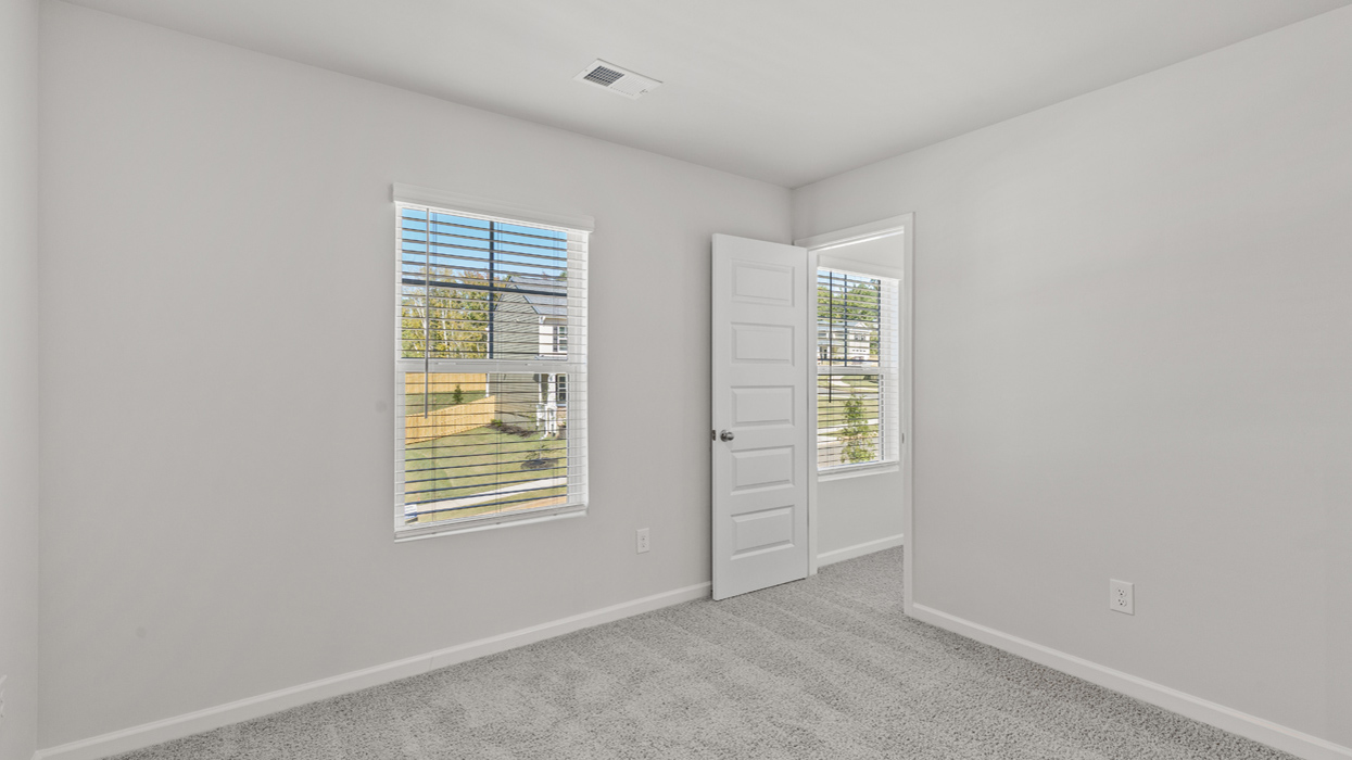 Guest bedroom upstairs with carpet and flush mount light