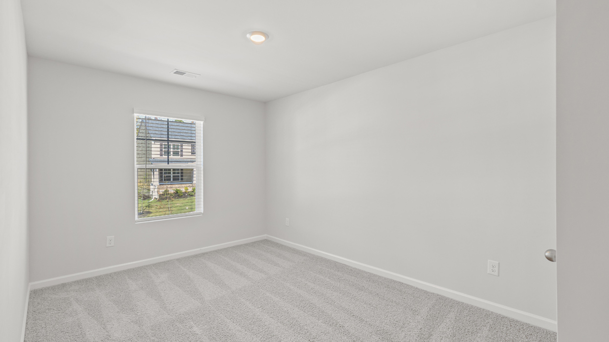 Guest bedroom upstairs with carpet and flush mount light