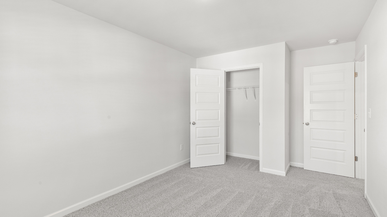 Guest bedroom upstairs with carpet and flush mount light