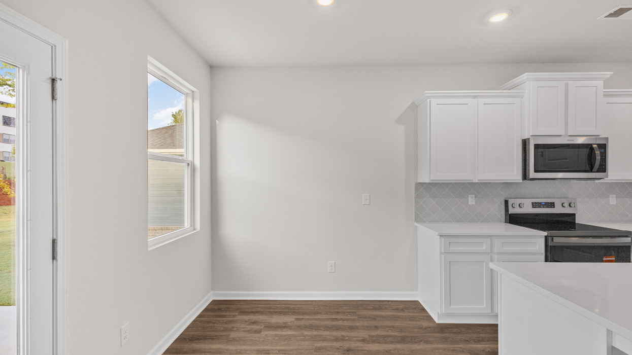 Eat-in-kitchen dining area with door to backyard.