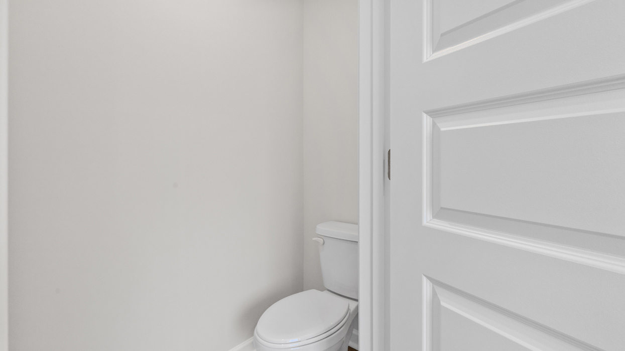 Water closet with commode in primary bath.