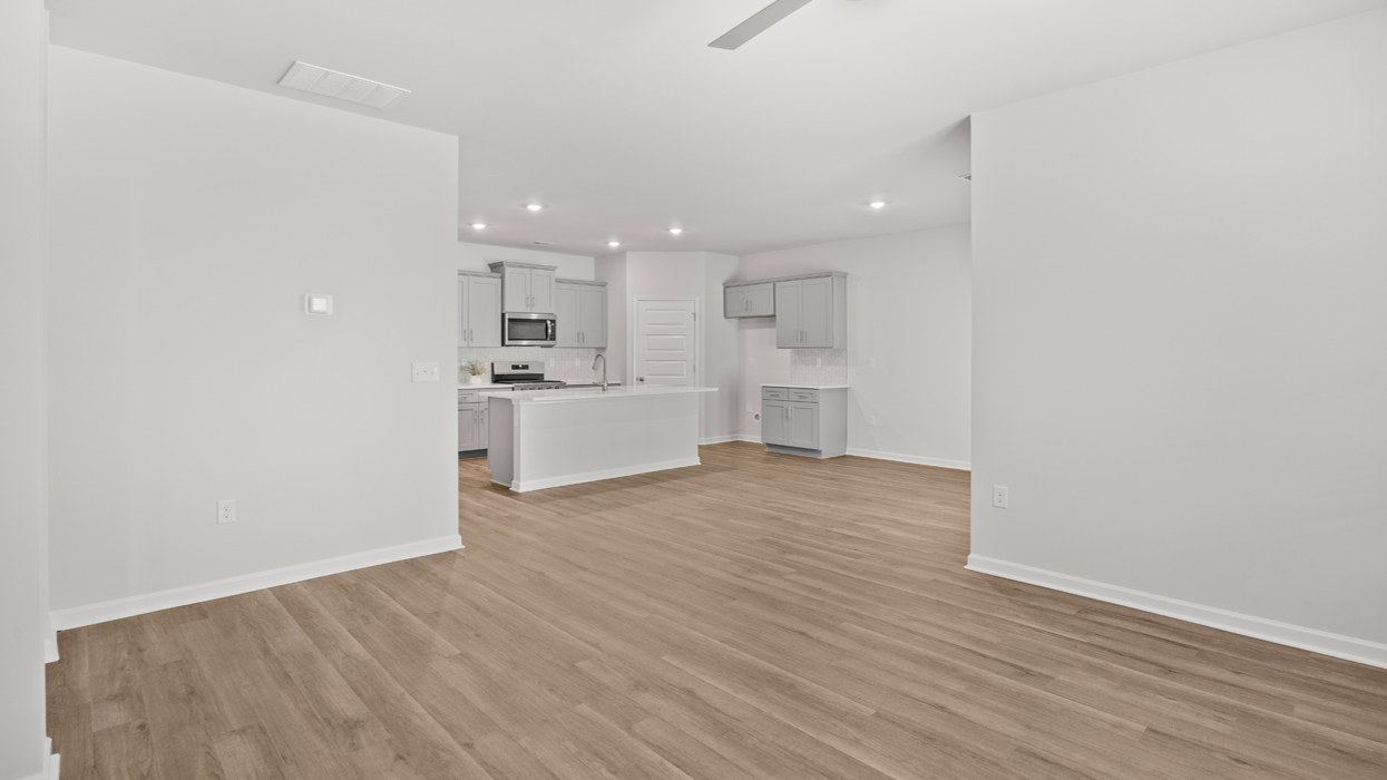 Open living room area off of kitchen and dining space.