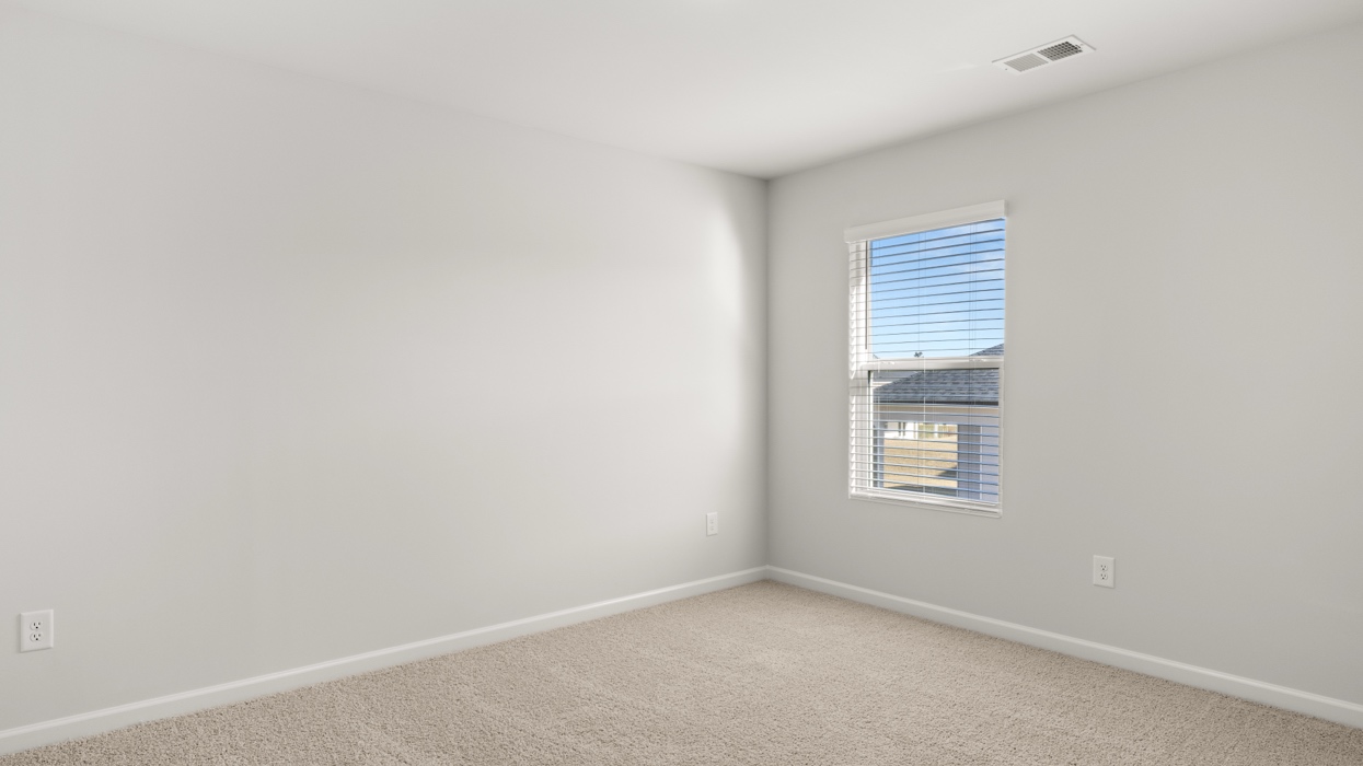 Carpeted guest bedroom upstairs