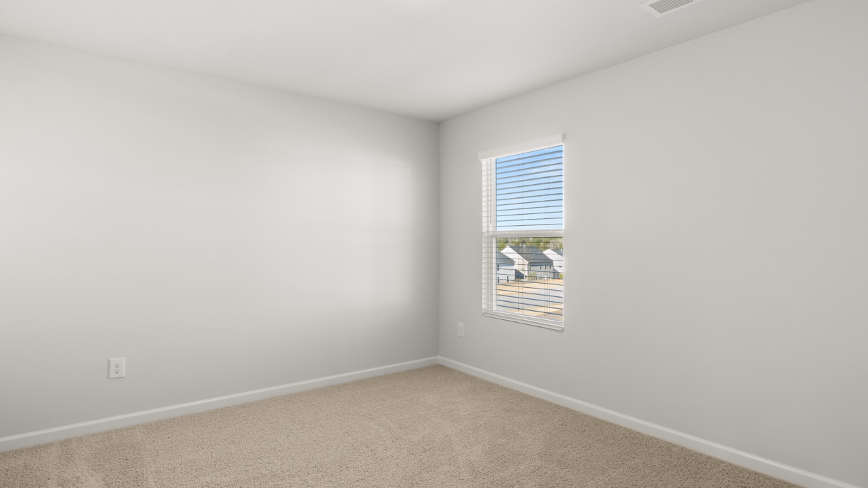 Carpeted guest bedroom upstairs