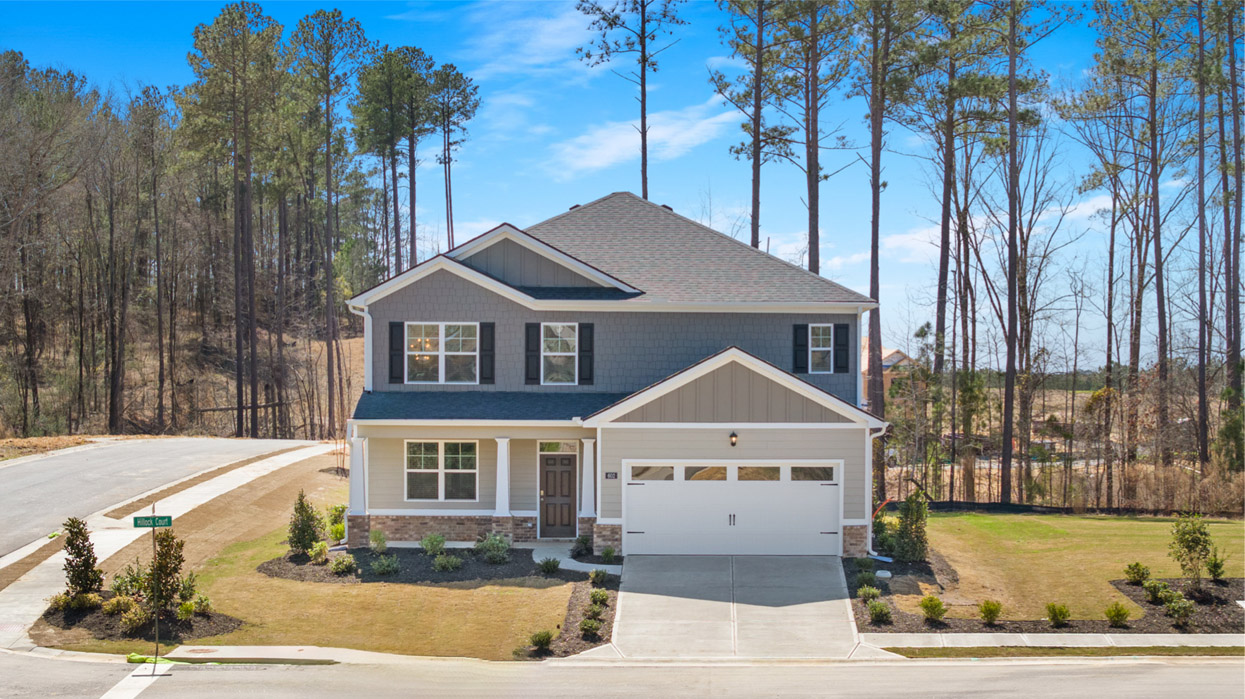 Two story grey home with a covered front porch and two car garage