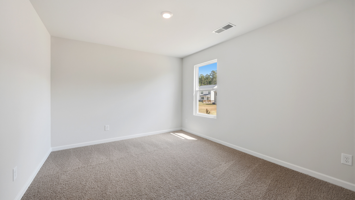 Guest bedroom upstairs with carpeting and closet.