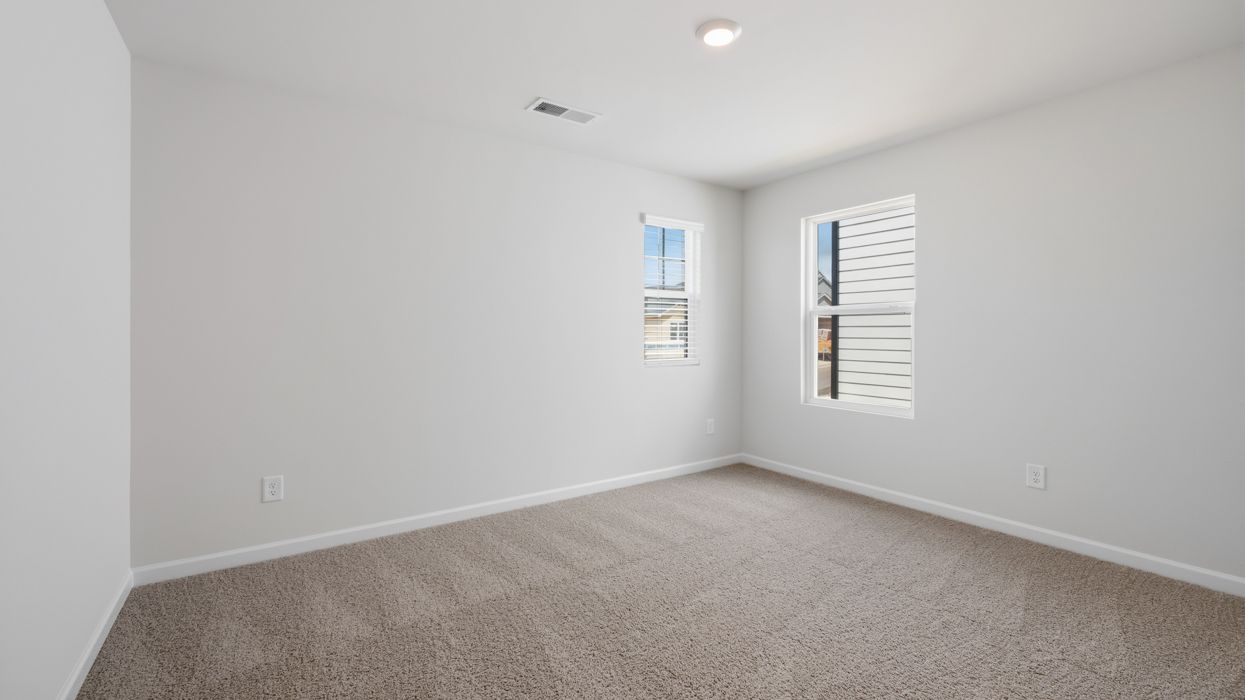 Guest bedroom upstairs with carpeting and closet.