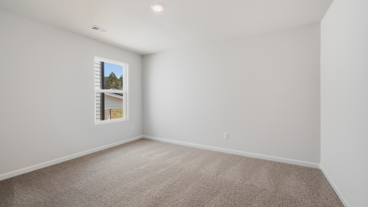 Guest bedroom upstairs with carpeting and closet.