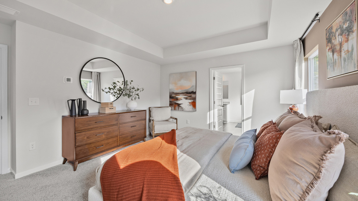 Primary bedroom with tray ceilings, huge closet, and en suite bath.