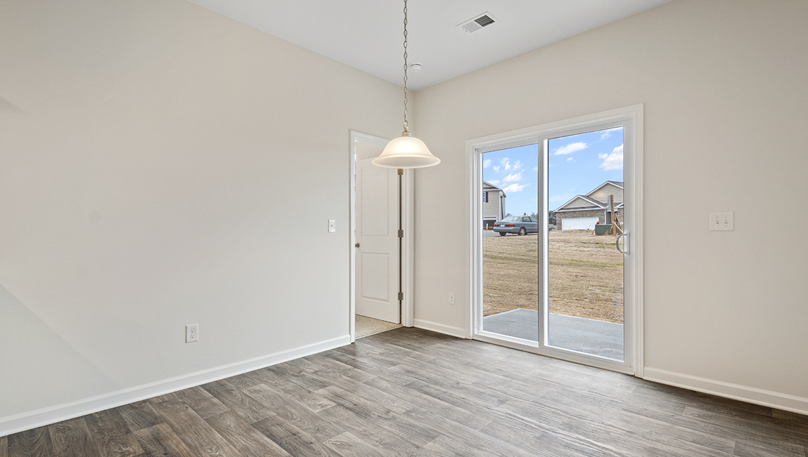 Dining area with wood floors and sliding glass back door