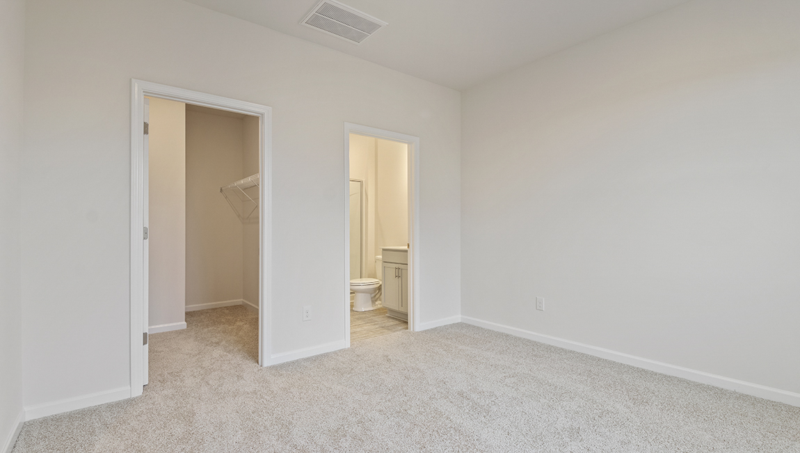 Carpeted bedroom with large window