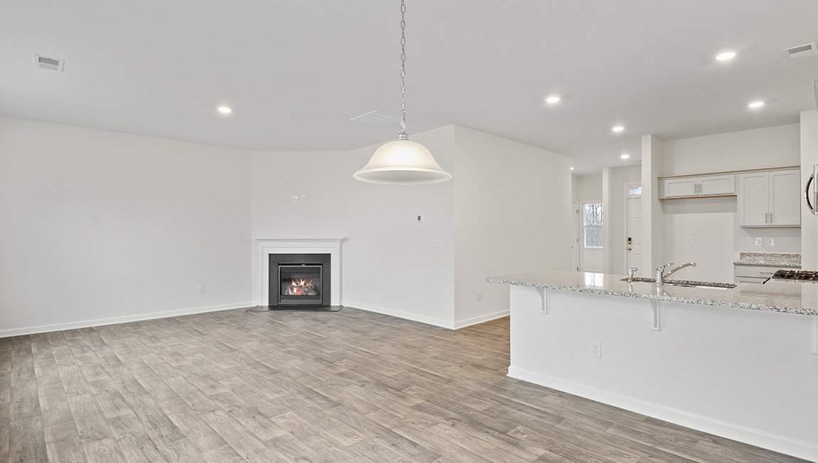 Kitchen and island with white cabinets and subway tiles and stainless steel subway tiles