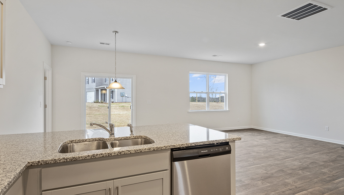 Kitchen and island with white cabinets and subway tiles and stainless steel subway tiles