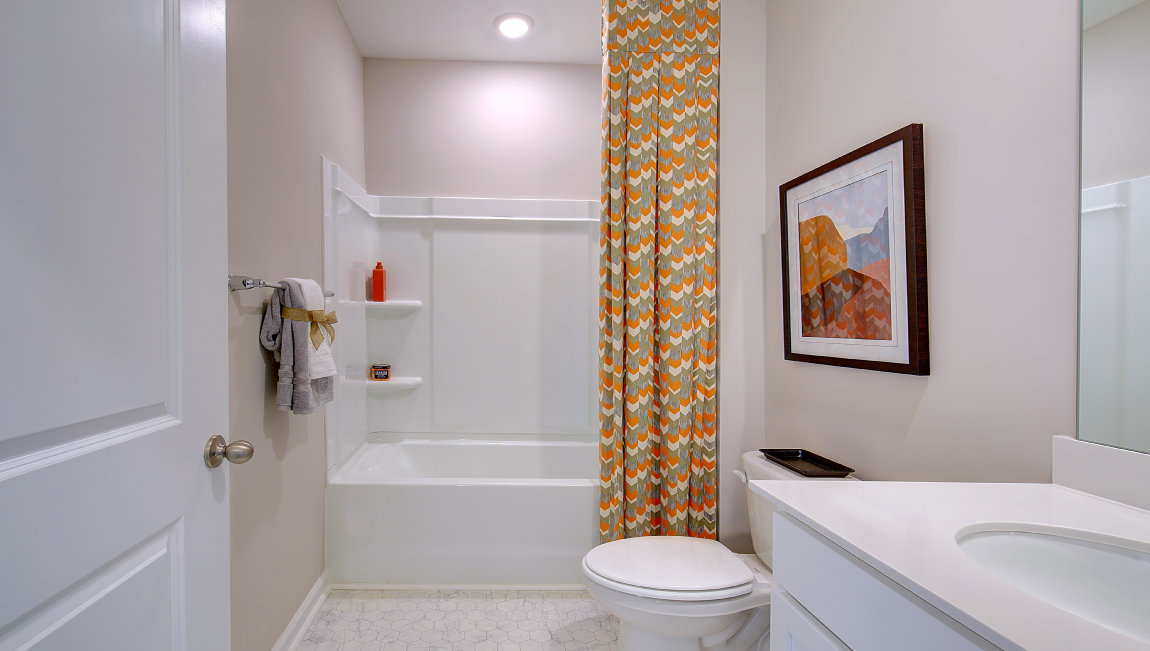 Bathroom with white cabinets and bathtub