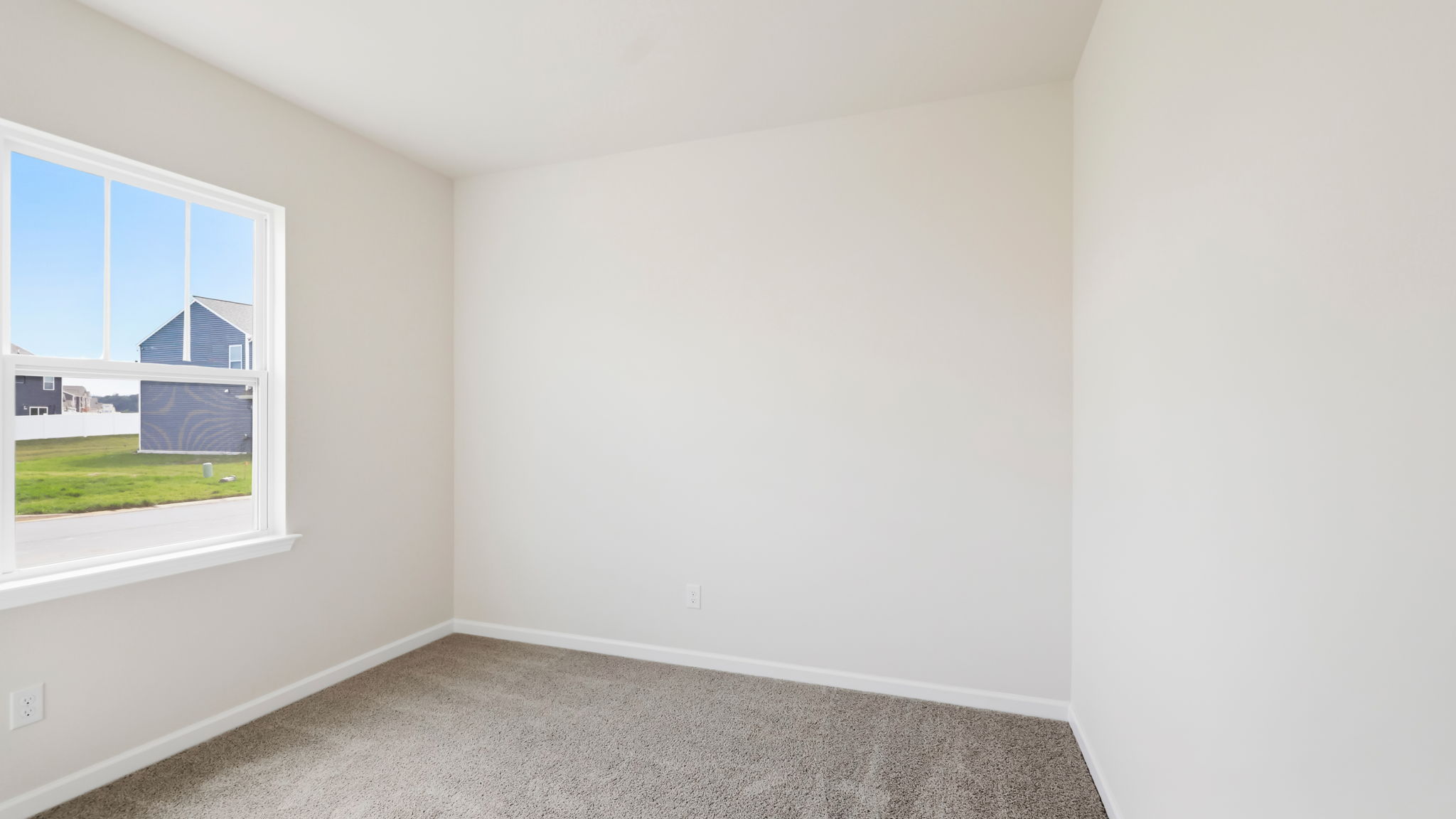 Carpeted bedroom with large window