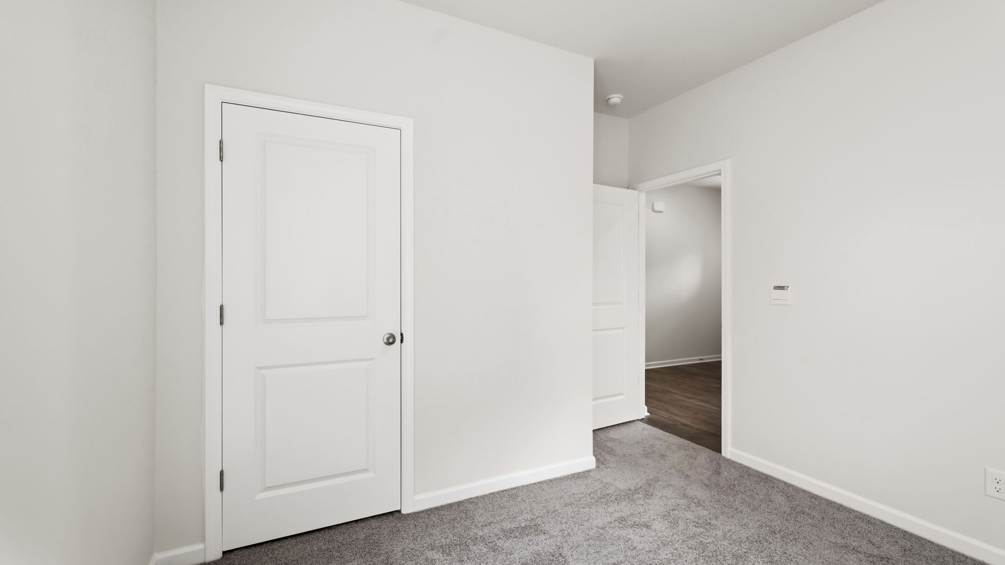 Carpeted bedroom with closet