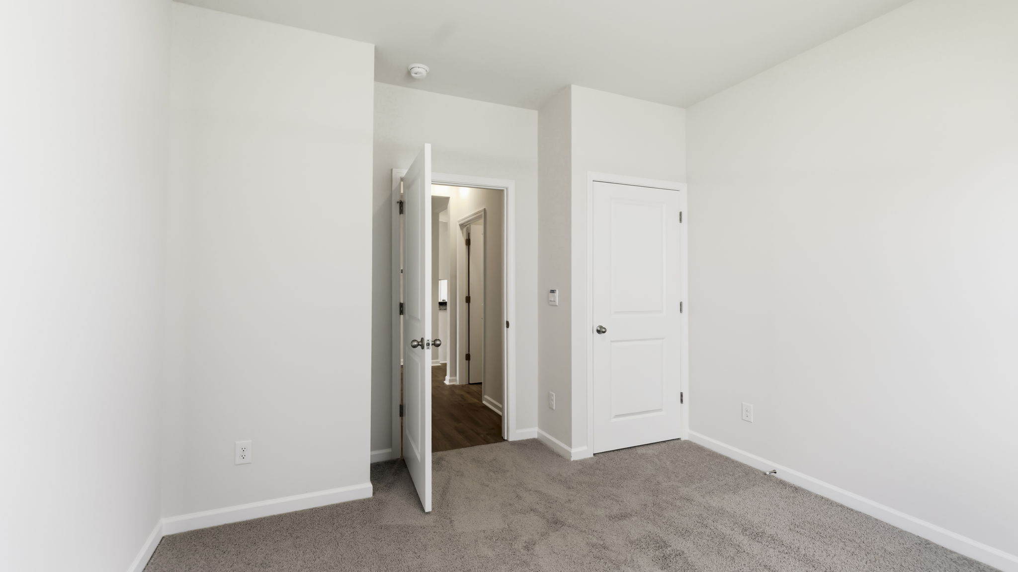 Carpeted bedroom with closet