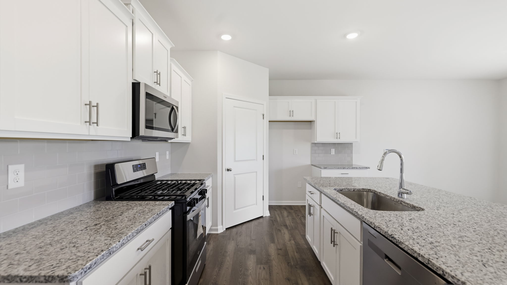 Open concept kitchen with large island and stainless steel appliances