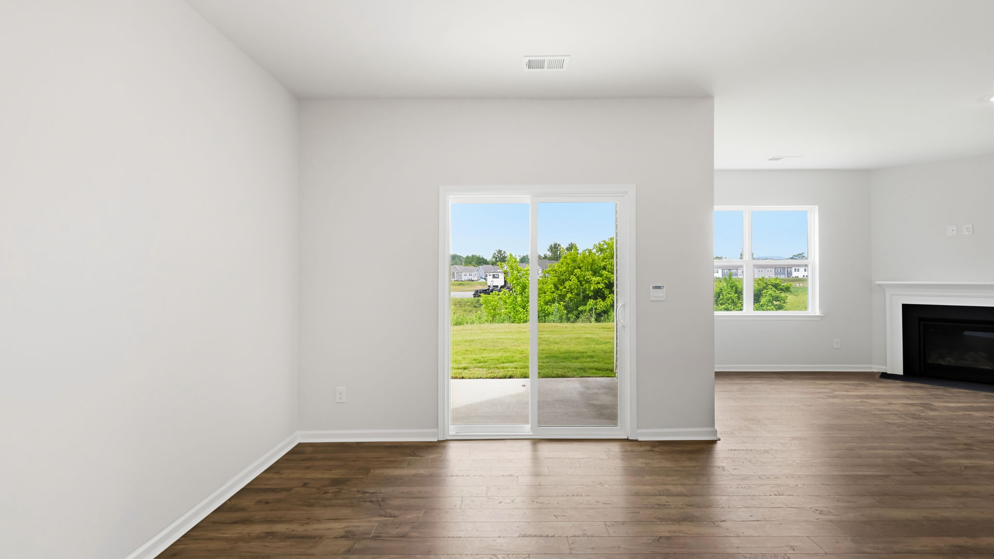 Open dining area with sliding glass doors and gas fireplace