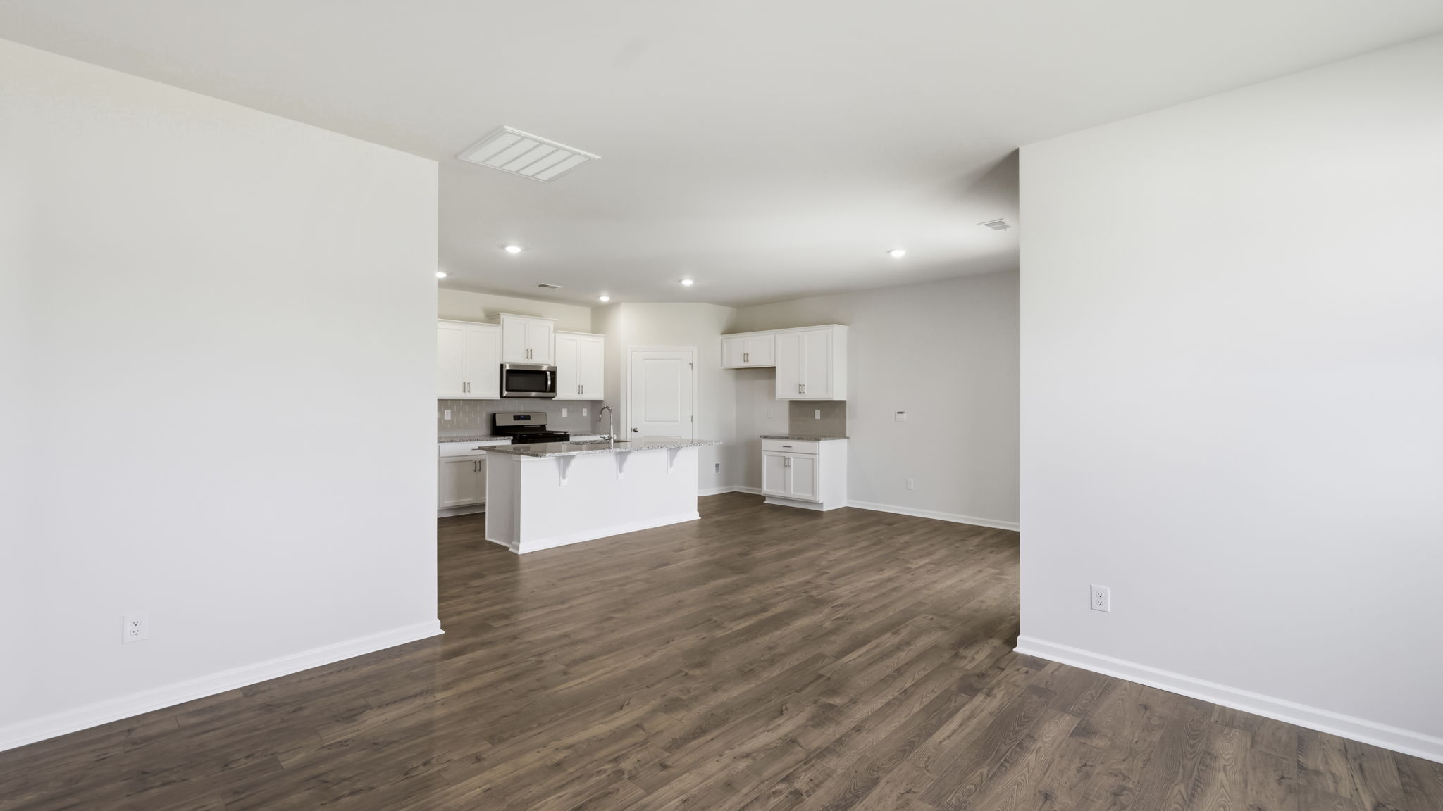 Open concept kitchen with large island and stainless steel appliances