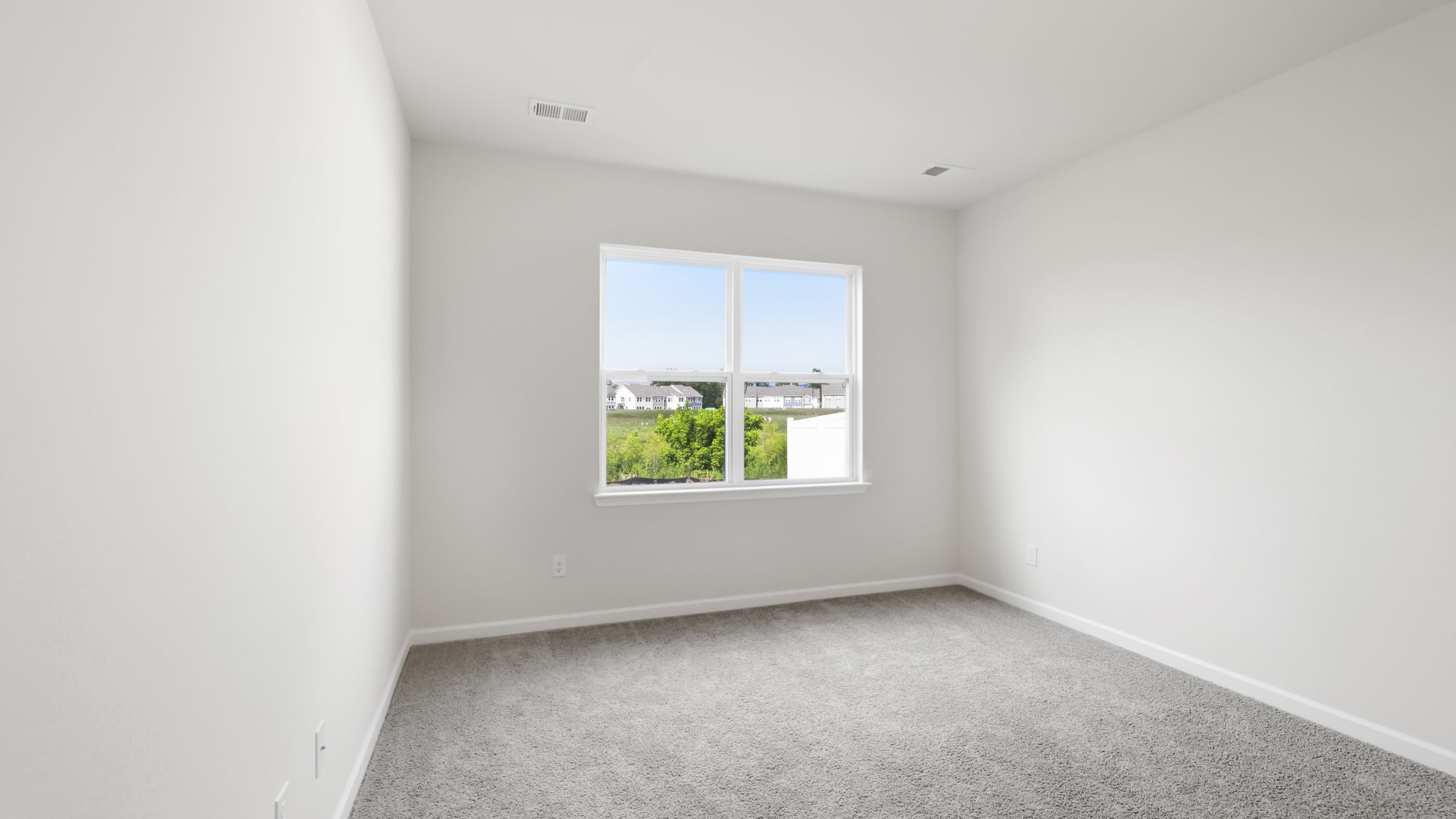 Carpeted bedroom with large window