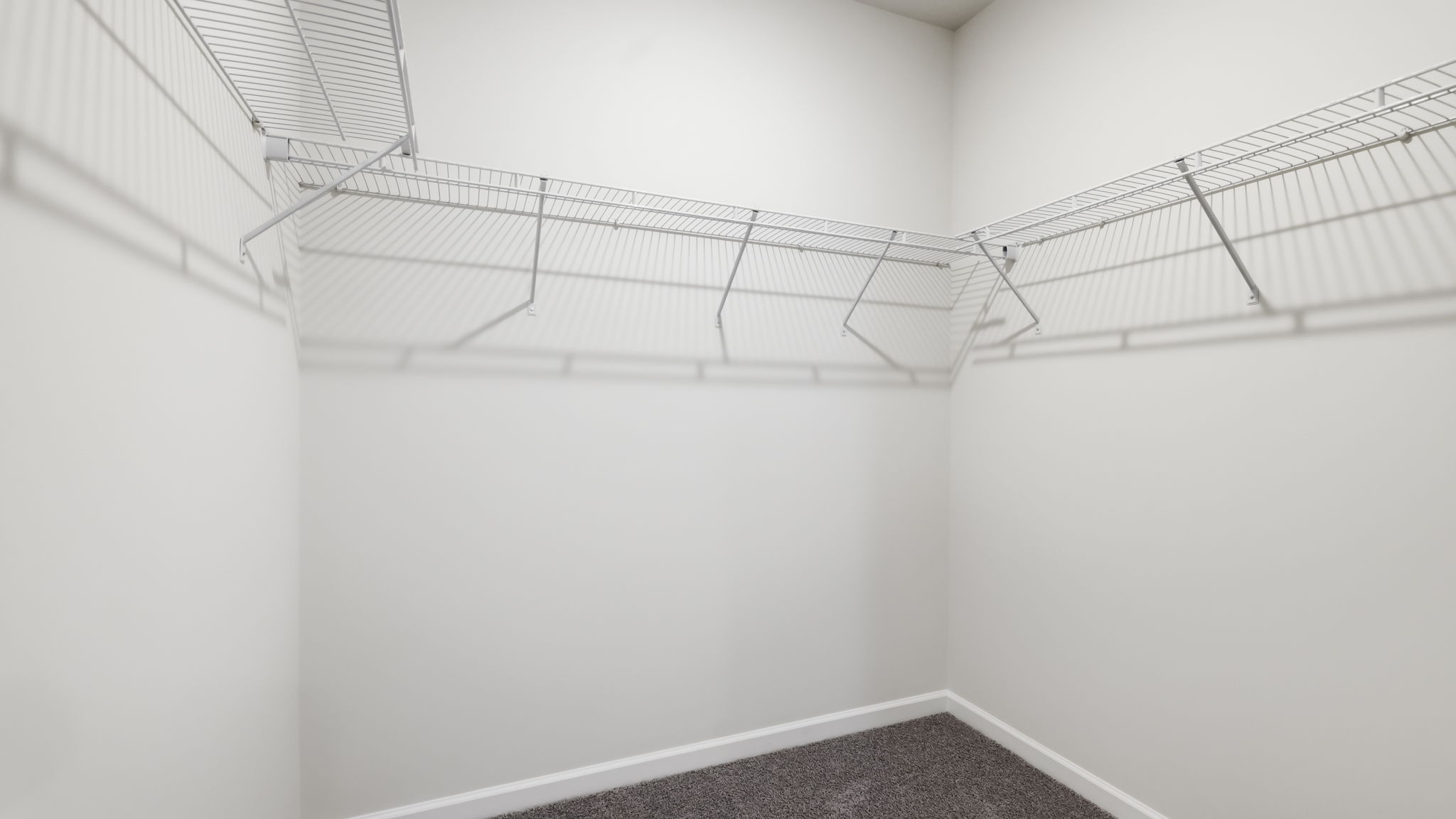 Primary walk in closet with shelving