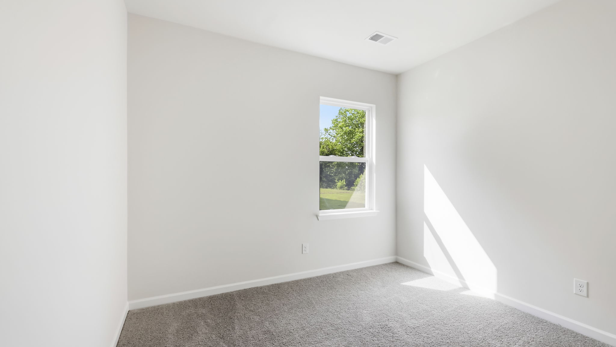 Carpeted bedroom with large windows