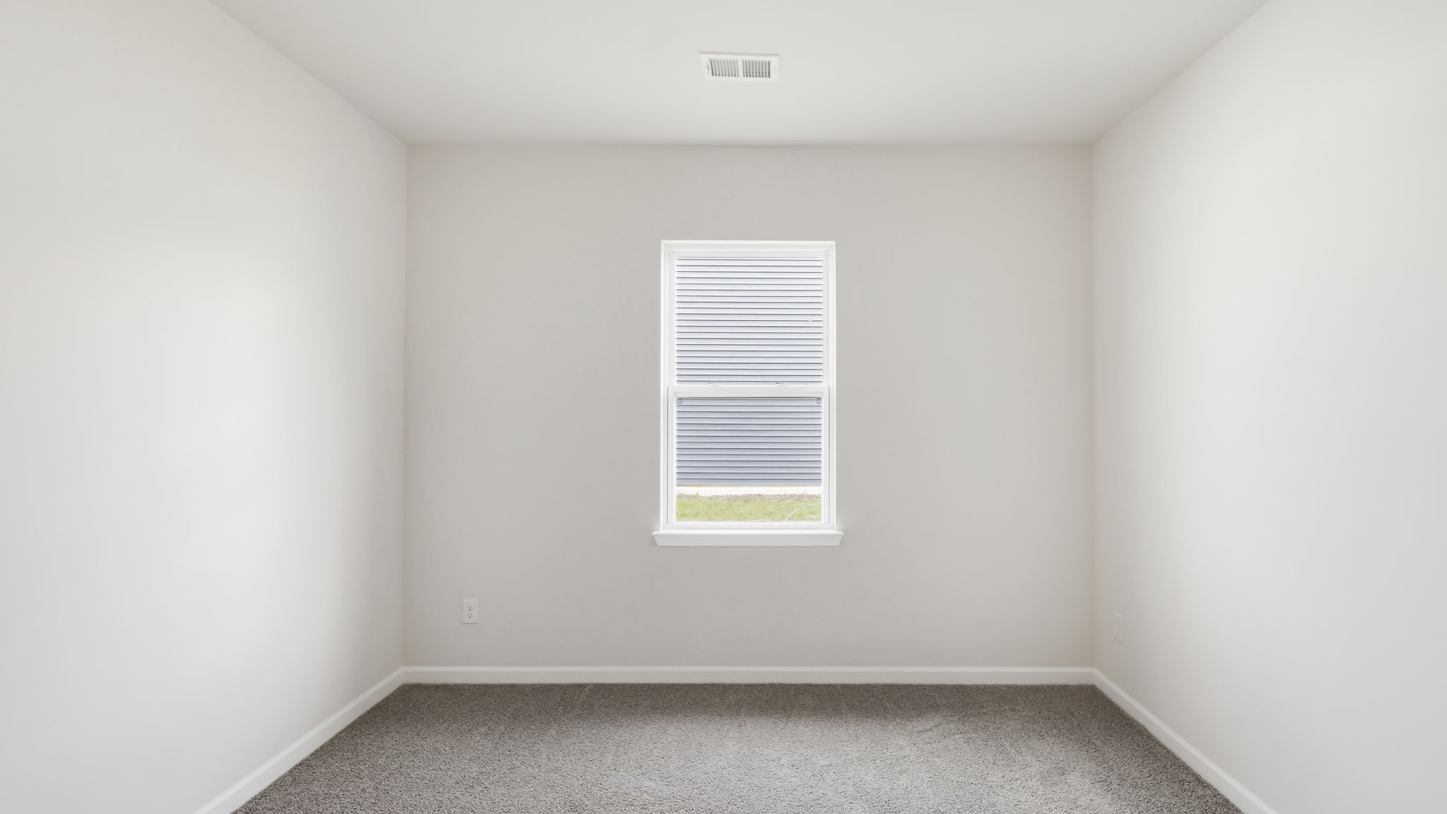 Carpeted bedroom with large windows