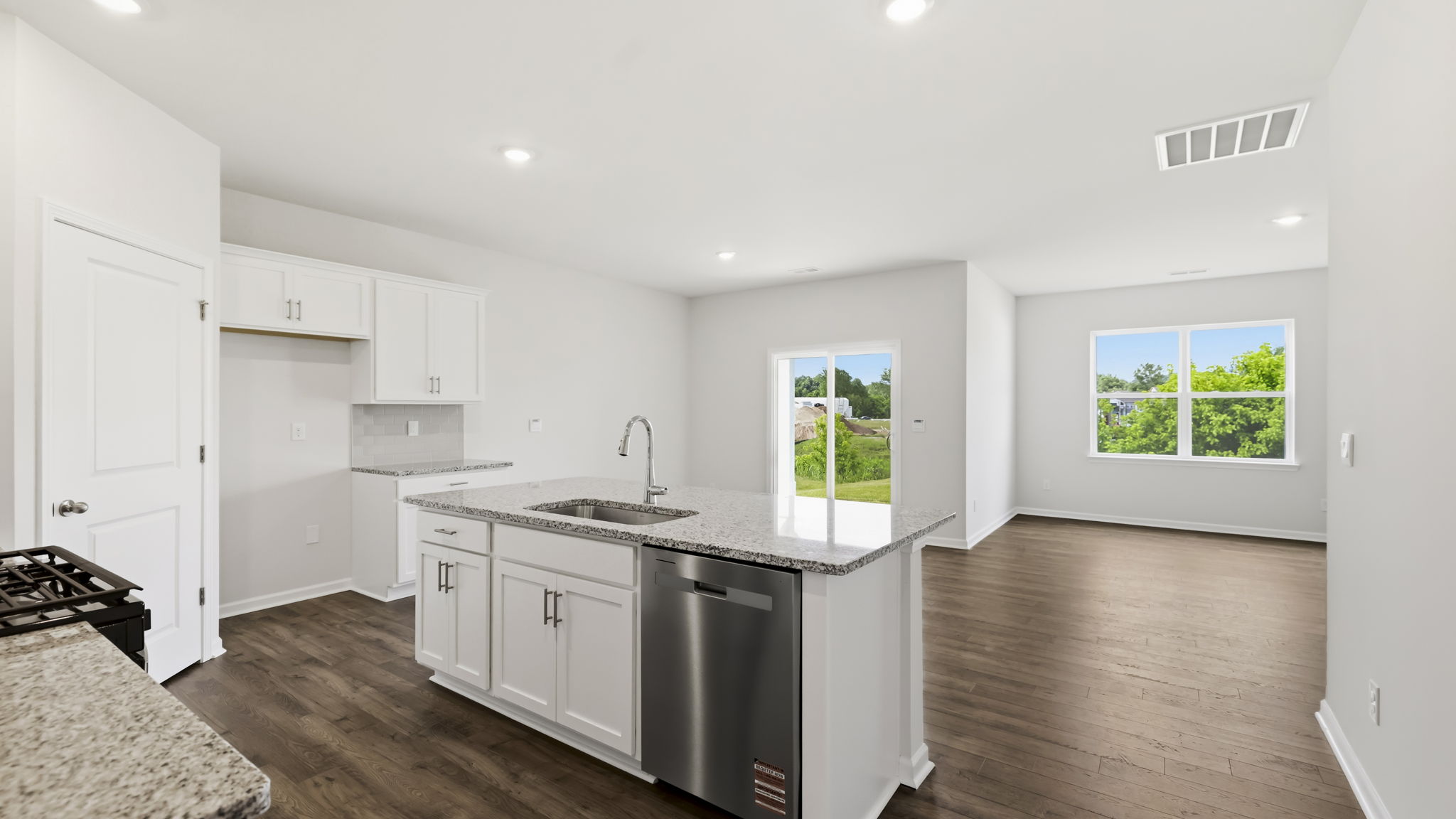 Open concept kitchen with stainless-steel appliances and large island