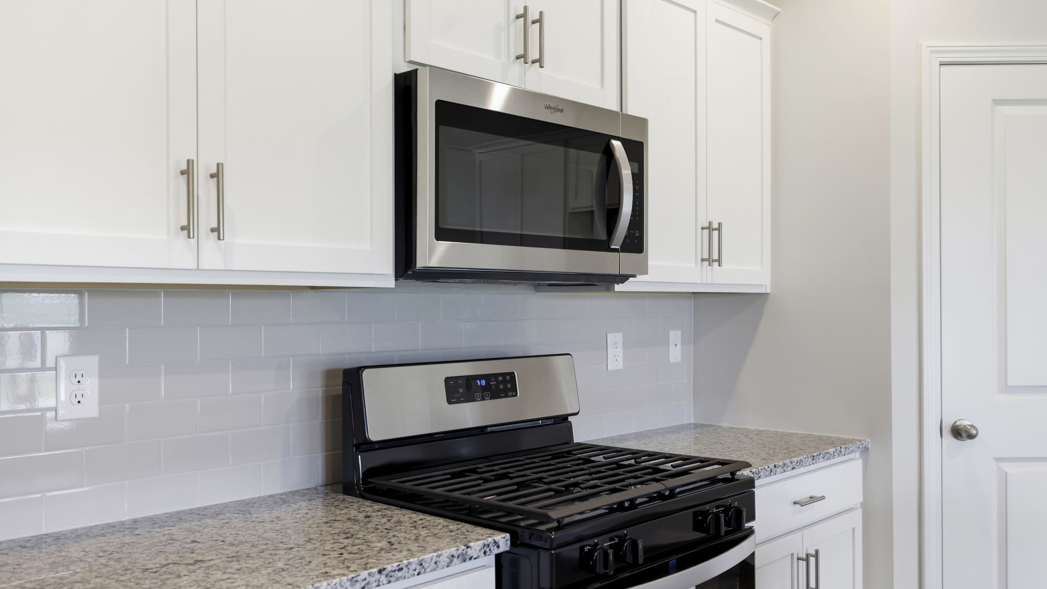 Open concept kitchen with stainless-steel appliances and large island