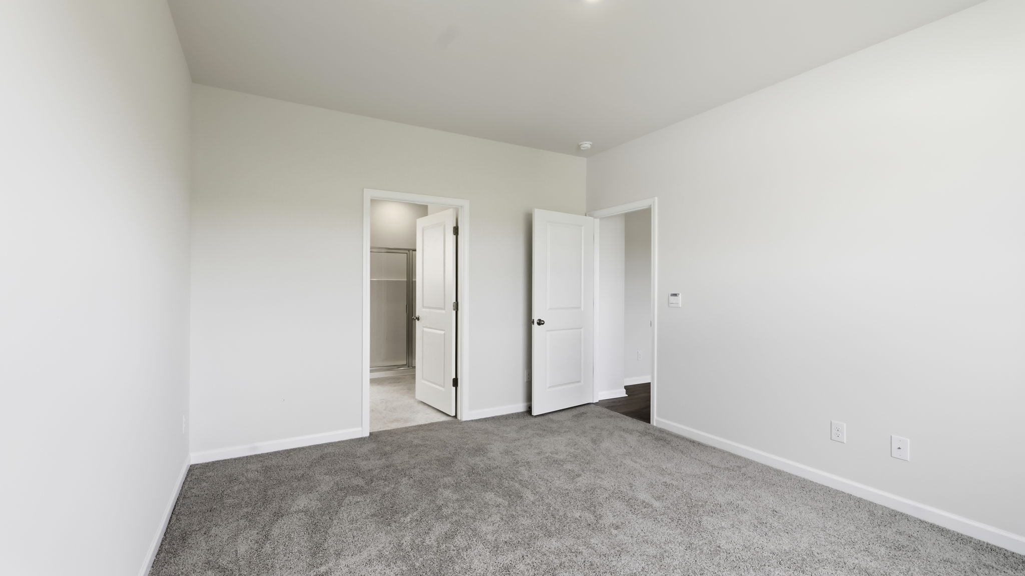 Carpeted bedroom with large windows