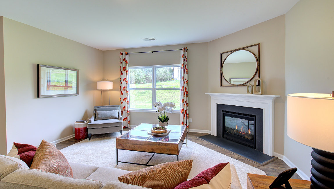 Open living room area with large windows and gas fireplace