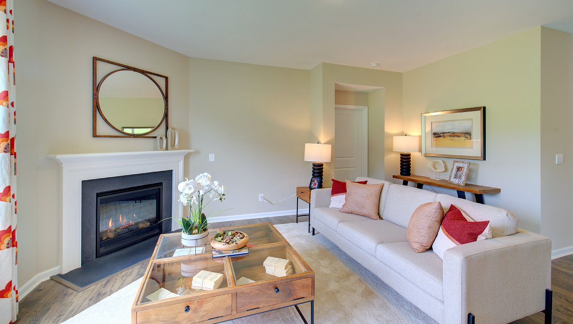 Open living room area with large windows and gas fireplace