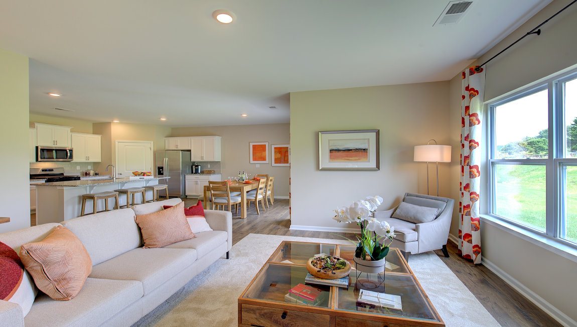 Open living room area with large windows and gas fireplace
