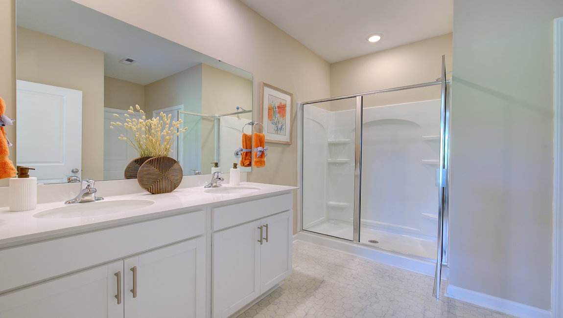 Primary bathroom with dual vanity and walk in shower