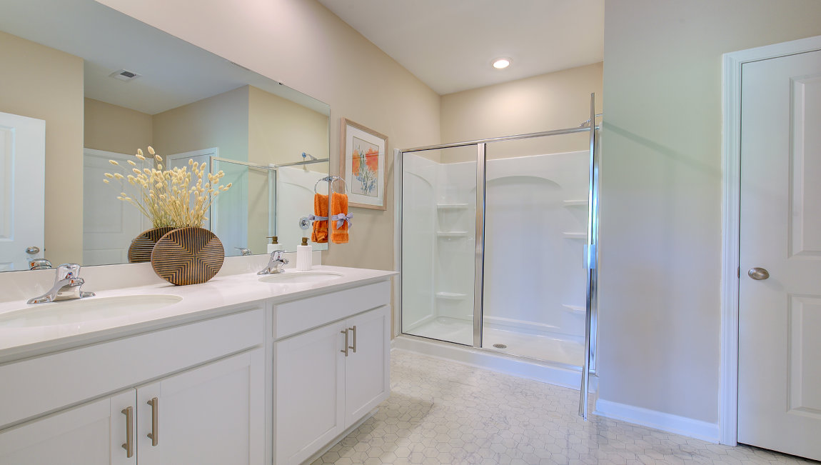 Primary bathroom with dual vanity and walk in shower