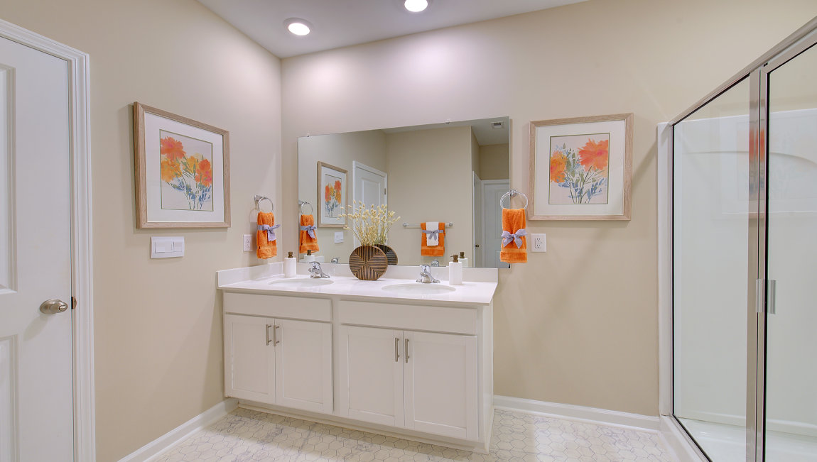 Primary bathroom with dual vanity and walk in shower