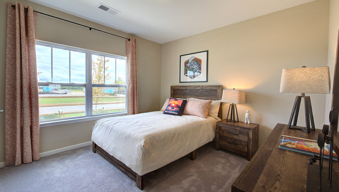 Carpeted bedroom with large windows