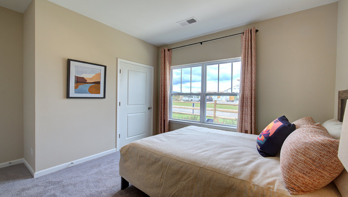 Carpeted bedroom with large windows