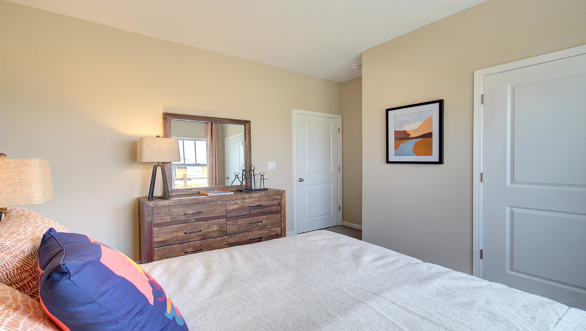 Carpeted bedroom with large windows